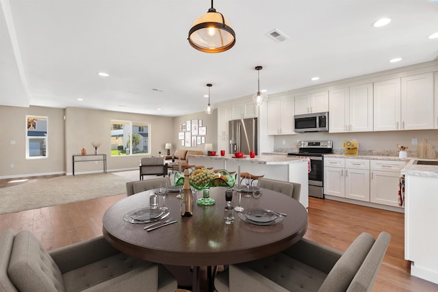 dining space with light wood-type flooring