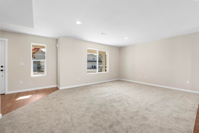 spare room featuring light colored carpet