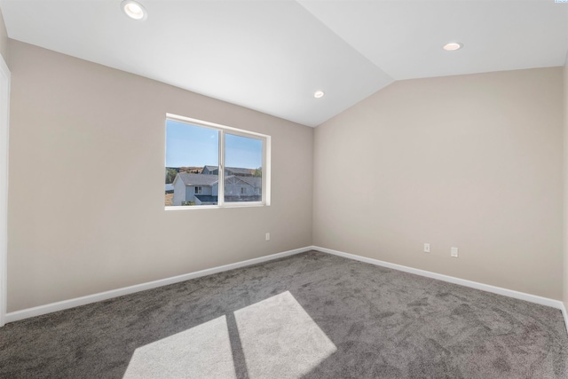 spare room featuring lofted ceiling and carpet