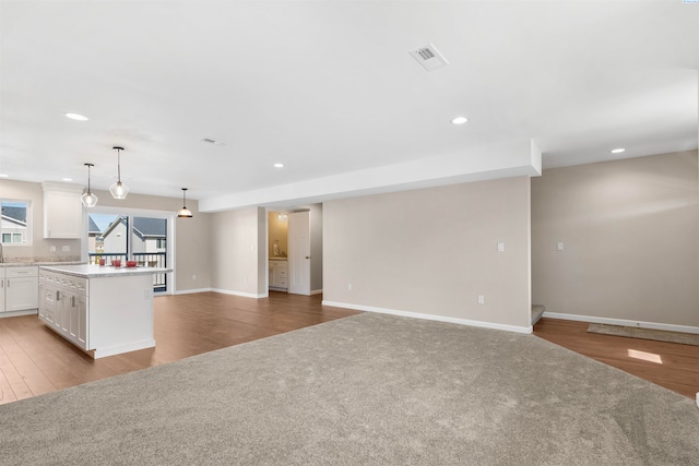 unfurnished living room featuring light colored carpet