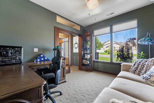 office with light colored carpet, baseboards, and a ceiling fan