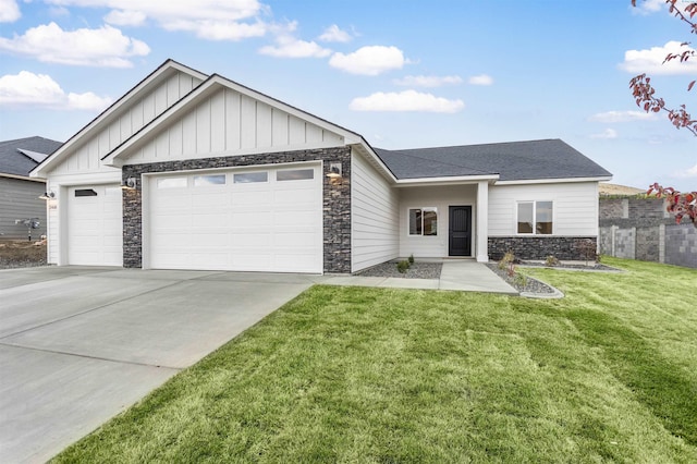 2408 Maggio Loop, Richland, WA 99352 - view of front of home featuring stone siding, a garage, board and batten siding, concrete driveway, and a front yard