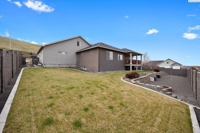 5298 S Quincy Pl, Kennewick, WA 99337 - exterior space featuring a yard, a fire pit, a fenced backyard, and stucco siding