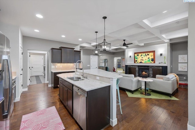 5298 S Quincy Pl, Kennewick, WA 99337 - kitchen with ceiling fan, dark wood-style flooring, a sink, stainless steel appliances, and coffered ceiling