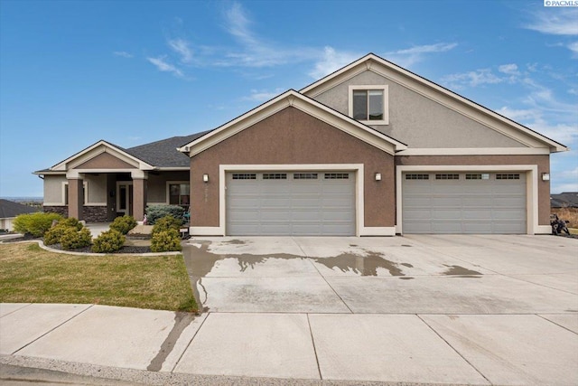 5298 S Quincy Pl, Kennewick, WA 99337 - view of front of property featuring an attached garage, driveway, and stucco siding