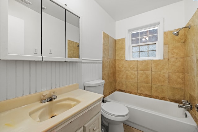 full bathroom with tiled shower / bath, vanity, and toilet