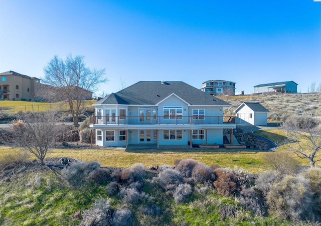 back of property featuring a yard and stairs