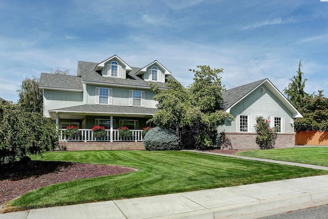 3114 Rd 103, Pasco, WA 99301 - view of front of house featuring roof with shingles, a front yard, and a porch