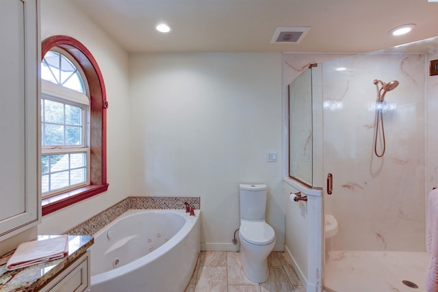 3114 Rd 103, Pasco, WA 99301 - full bathroom with a jetted tub, recessed lighting, toilet, a marble finish shower, and visible vents