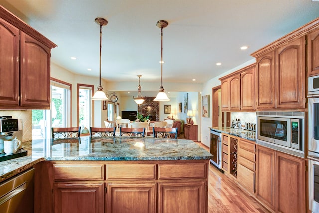 3114 Rd 103, Pasco, WA 99301 - kitchen with tasteful backsplash, a peninsula, beverage cooler, and stainless steel appliances