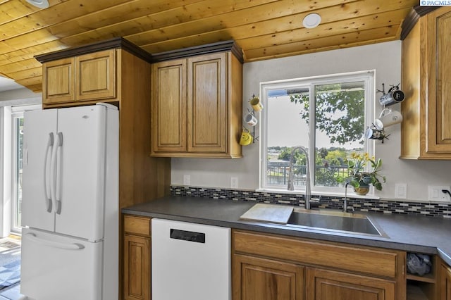 141 Travis Ln, Kennewick, WA 99338 - kitchen with white appliances, wooden ceiling, dark countertops, backsplash, and brown cabinetry