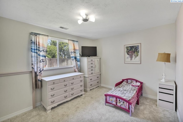 141 Travis Ln, Kennewick, WA 99338 - bedroom featuring light colored carpet and a textured ceiling