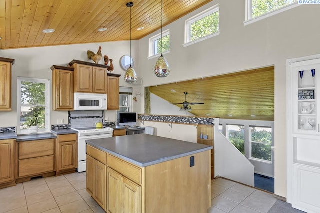 141 Travis Ln, Kennewick, WA 99338 - kitchen featuring white appliances, wood ceiling, dark countertops, light tile patterned floors, and a high ceiling