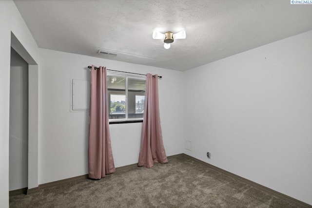 141 Travis Ln, Kennewick, WA 99338 - carpeted spare room with a textured ceiling and baseboards