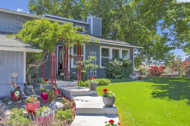 141 Travis Ln, Kennewick, WA 99338 - doorway to property with a chimney, a yard, and board and batten siding