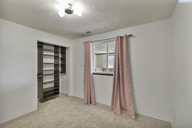141 Travis Ln, Kennewick, WA 99338 - unfurnished bedroom featuring light carpet, a textured ceiling, and a closet