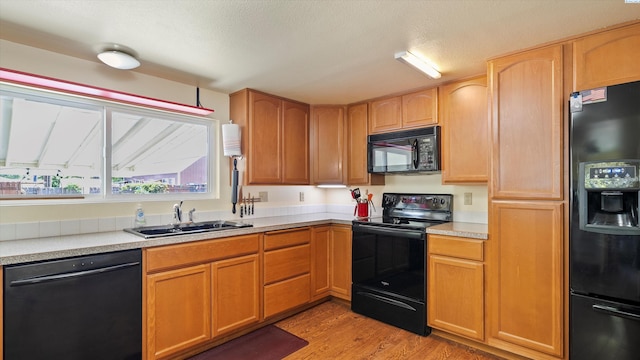 1707 W 19th Ave, Kennewick, WA 99337 - kitchen featuring black appliances, light wood-type flooring, and light countertops
