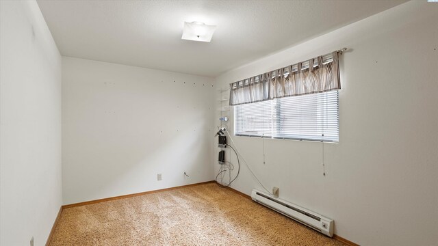1707 W 19th Ave, Kennewick, WA 99337 - spare room featuring a baseboard radiator and light colored carpet