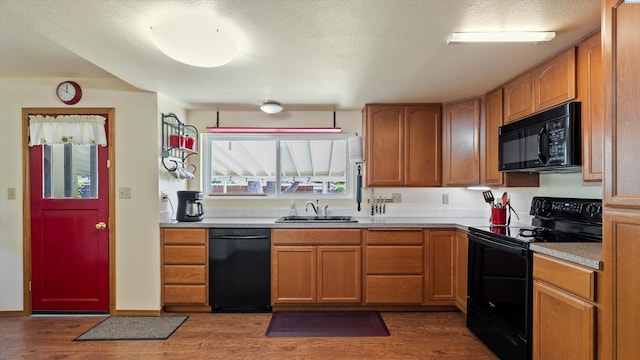 1707 W 19th Ave, Kennewick, WA 99337 - kitchen featuring black appliances, dark wood-style flooring, a textured ceiling, light countertops, and brown cabinetry