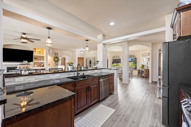4507 Indian Rdg, Pasco, WA 99301 - kitchen with stainless steel appliances, arched walkways, a sink, a ceiling fan, and open floor plan
