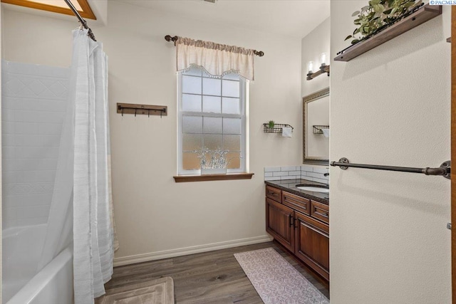 4507 Indian Rdg, Pasco, WA 99301 - full bath with vanity, wood finished floors, shower / bath combination with curtain, baseboards, and backsplash