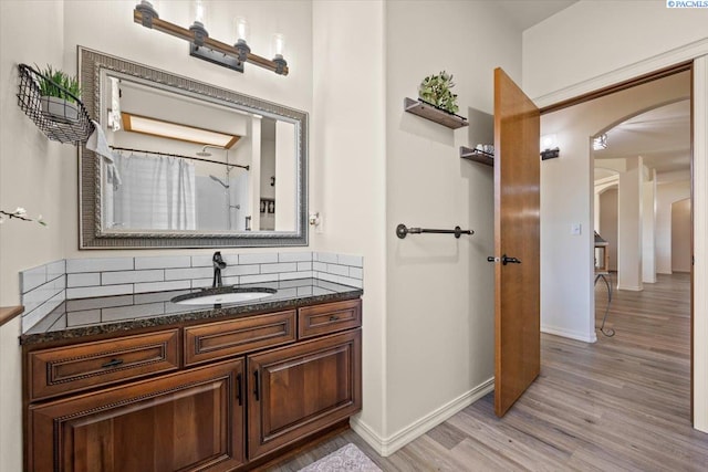 4507 Indian Rdg, Pasco, WA 99301 - bathroom featuring wood finished floors, vanity, baseboards, backsplash, and a shower with shower curtain