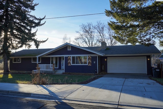 ranch-style home featuring a garage and covered porch