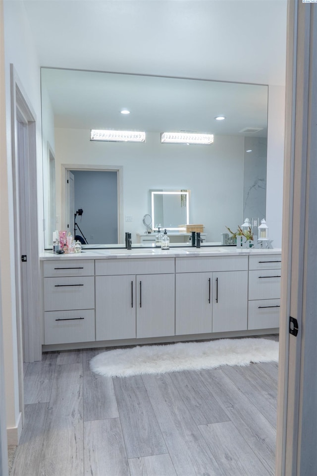 bathroom featuring vanity and hardwood / wood-style floors