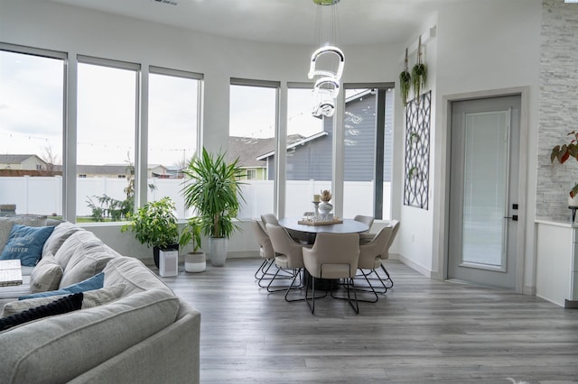 sunroom / solarium featuring a water view