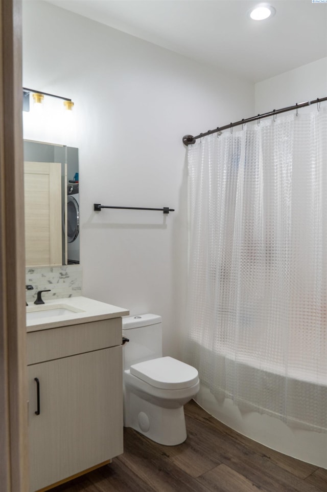 full bathroom featuring wood-type flooring, decorative backsplash, vanity, shower / tub combo, and toilet