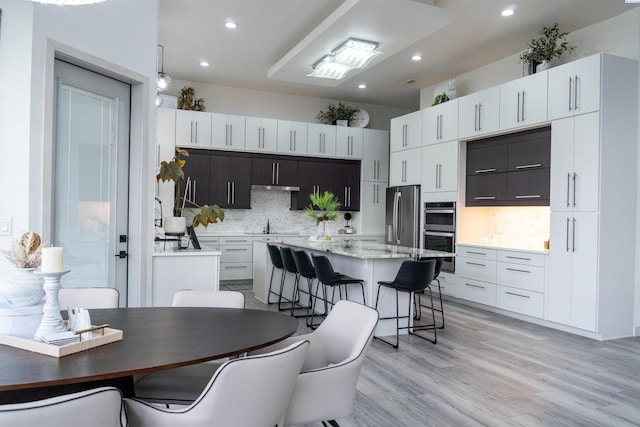 kitchen featuring white cabinetry, stainless steel appliances, and a kitchen island