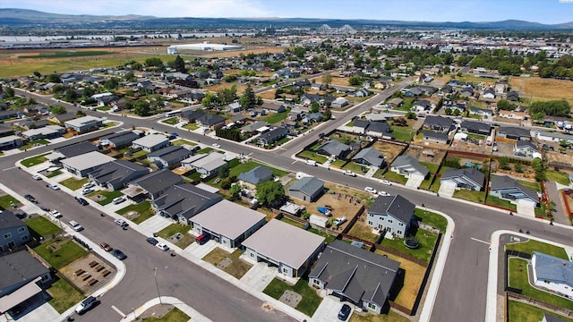 412 Whitefish Ln, Pasco, WA 99301 - aerial overview of property's location with a mountainous background and nearby suburban area