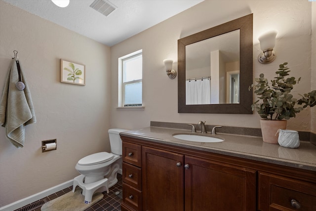 3321 W 24th Ave, Kennewick, WA 99337 - bathroom with vanity, toilet, baseboards, and tile patterned floors