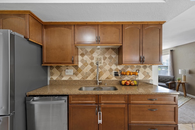 3321 W 24th Ave, Kennewick, WA 99337 - kitchen with stainless steel appliances, a sink, tasteful backsplash, and light stone countertops