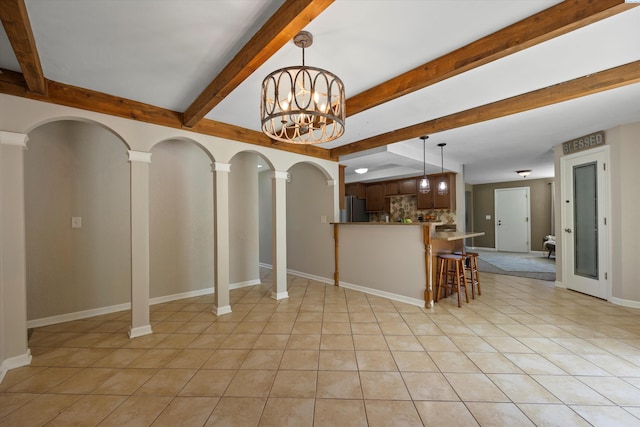 3321 W 24th Ave, Kennewick, WA 99337 - living room with beam ceiling, light tile patterned floors, baseboards, and a chandelier