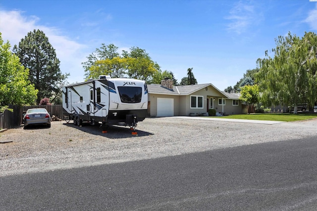 3321 W 24th Ave, Kennewick, WA 99337 - view of front of house featuring a garage, a chimney, and gravel driveway