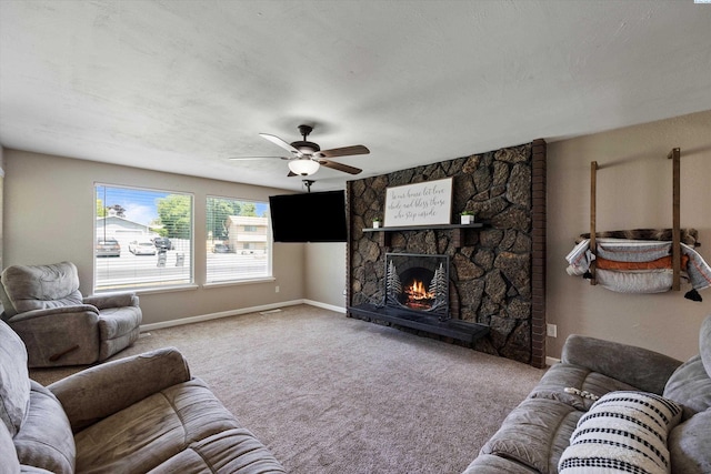 3321 W 24th Ave, Kennewick, WA 99337 - carpeted living area with a stone fireplace, baseboards, and a ceiling fan