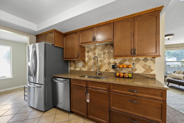 3321 W 24th Ave, Kennewick, WA 99337 - kitchen featuring appliances with stainless steel finishes, a sink, decorative backsplash, and stone countertops