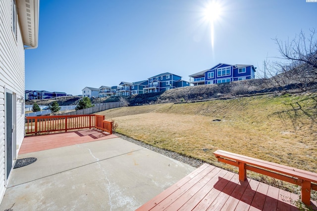 exterior space featuring a patio area, a residential view, a deck, and fence