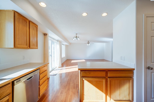 kitchen featuring dishwasher, light countertops, light wood-style flooring, and recessed lighting