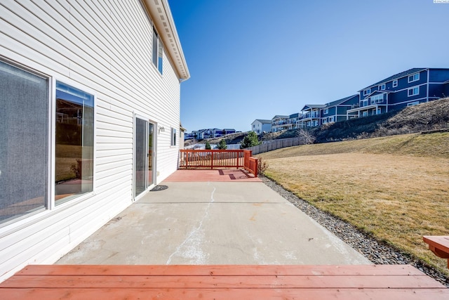 view of patio / terrace with a residential view and fence