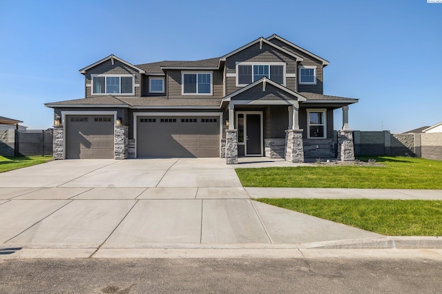 craftsman-style house featuring a garage and a front lawn