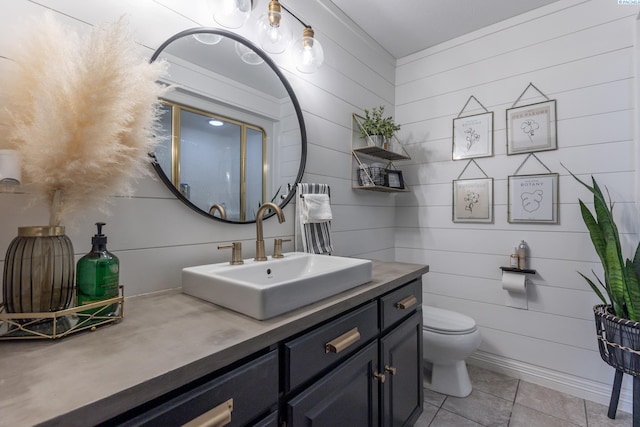 bathroom with tile patterned flooring, vanity, and toilet