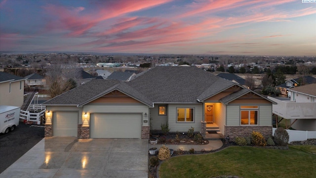 craftsman-style home featuring a garage and a lawn