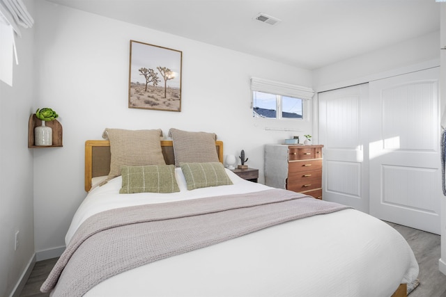 bedroom featuring hardwood / wood-style floors and a closet