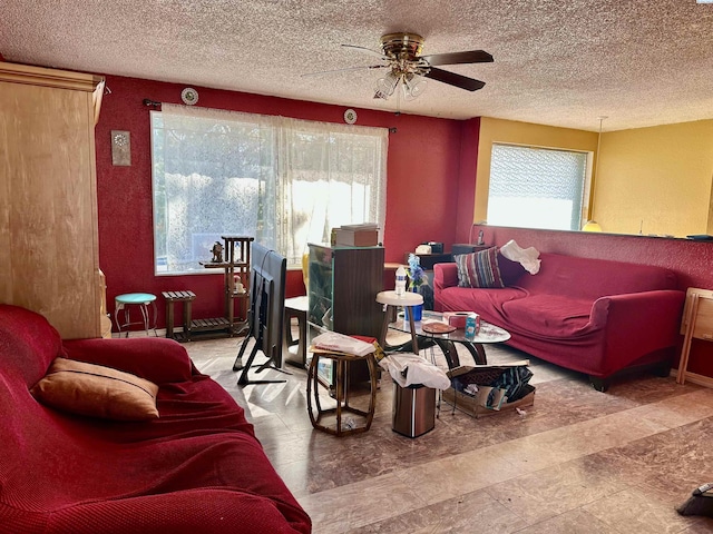 living room featuring a textured ceiling and a ceiling fan