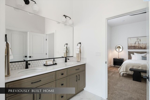 6653 W 27th Ave Unit 26, Kennewick, WA 99338 - bathroom featuring double vanity, tasteful backsplash, connected bathroom, and marble look tiles