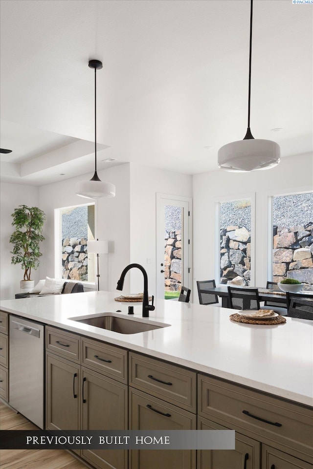 6653 W 27th Ave Unit 26, Kennewick, WA 99338 - kitchen featuring stainless steel dishwasher, open floor plan, light countertops, pendant lighting, and plenty of natural light