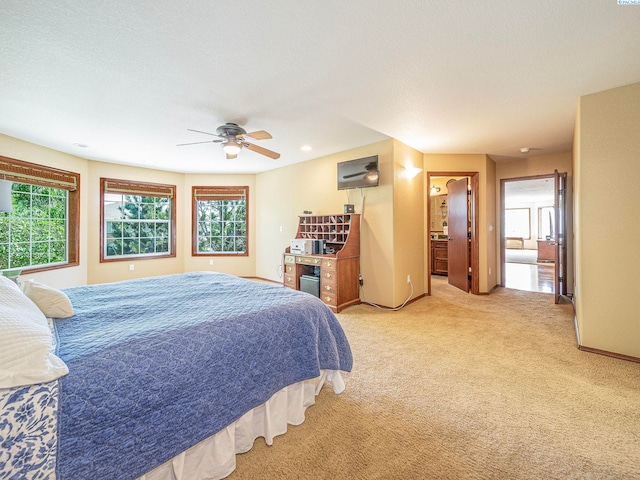 9203 Yakima Ct, Yakima, WA 98908 - bedroom featuring light colored carpet, ensuite bath, baseboards, recessed lighting, and ceiling fan