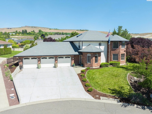 9203 Yakima Ct, Yakima, WA 98908 - traditional home with a garage, brick siding, and driveway